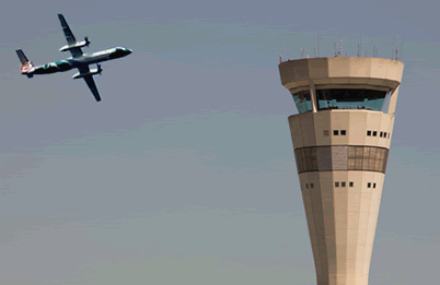 an airplane and communications tower