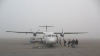 aircraft on tarmac with fog